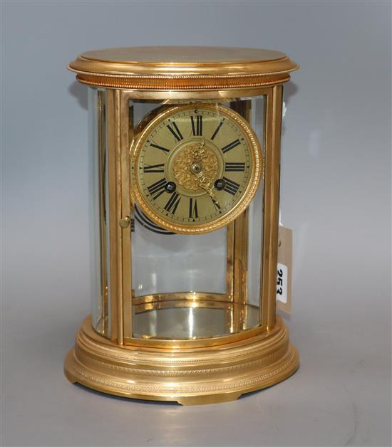 A 19th century French gilt brass four-hour mantel clock, of oval form, with silvered dial height 25cm